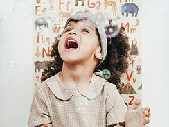 Child playing with bubbles