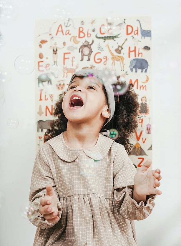 Child playing with bubbles