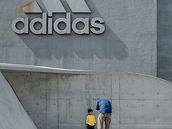 Father and son in front of the adidas building