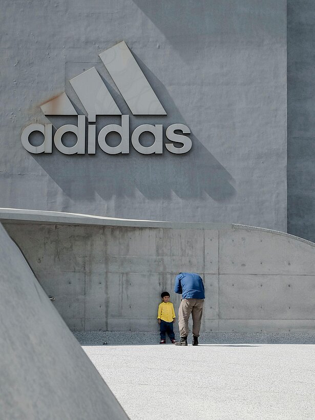 Father and son in front of the adidas building