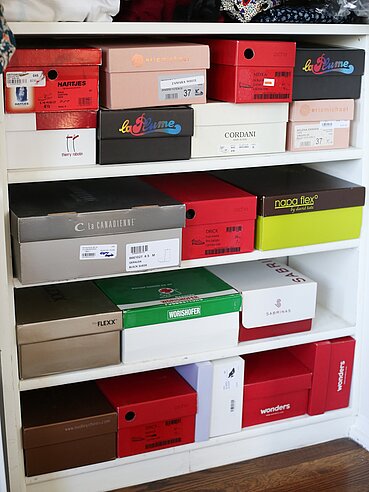 Mixed shoeboxes in shelf at home